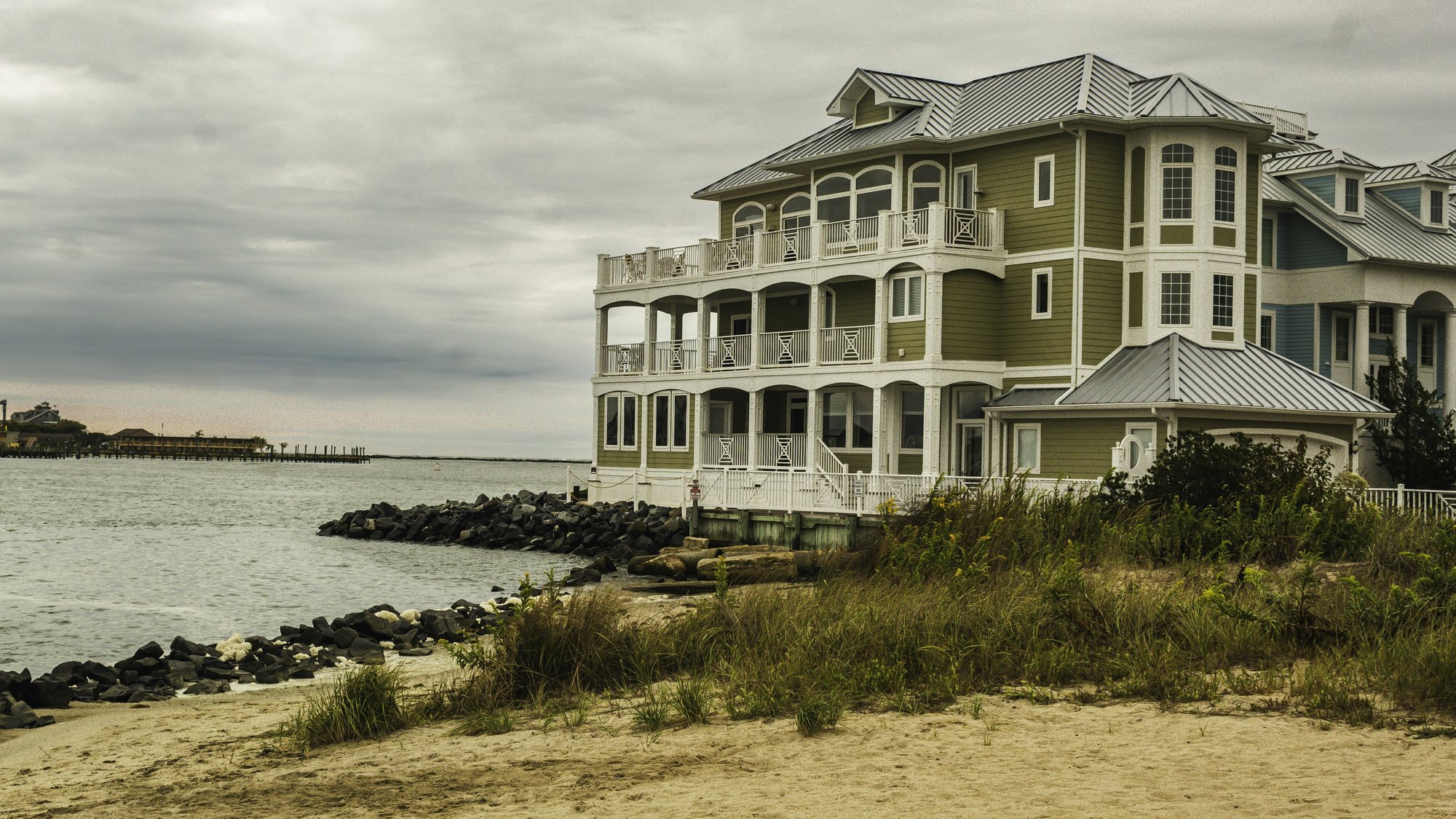 A three-story beach house above a rock jetty in Ocean City, Maryland